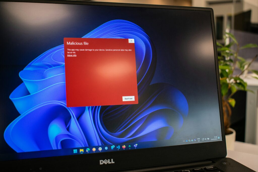 Malicious file warning on a windows laptop by Ed Hardie on Unsplash: https://unsplash.com/photos/a-dell-laptop-computer-with-a-red-screen-1C5F88Af9ZU