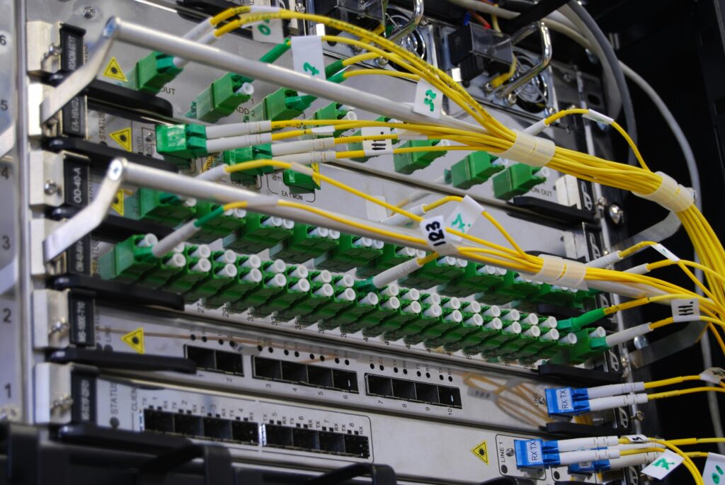 Network rack with bundled cables by Kirill Sh on Unsplash: https://unsplash.com/photos/green-and-white-electric-device-eVWWr6nmDf8