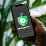 Man looking at his phone screen with a vpn on it.