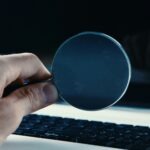 Person looking through a magnifying glass at a computer screen by Sasun Bughdaryan on Unsplash: https://unsplash.com/photos/person-holding-round-blue-frame-5T0MpCaw7gM